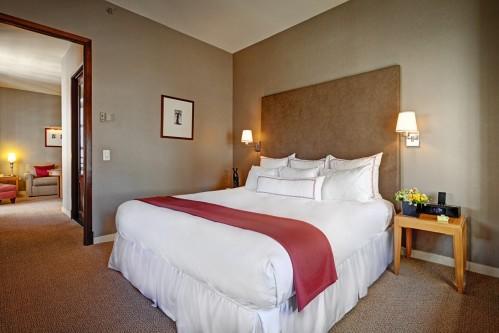 The bedroom area of the One Bedroom Suite offers a King Size Bed. Enjoy a serene evening of rest!